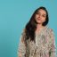 Happy brunette woman confident with natural hair, feeling satisfied Portrait of cheerful friendly indian woman smiling, flipping long healthy hair, isolated over studio background. Happy brunette person confident with natural hairstyle, feeling satisfied, camera A