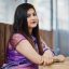Indian hindu girl at traditional violet saree sitting at cafe ta Indian hindu girl at traditional violet saree sitting at cafe table.